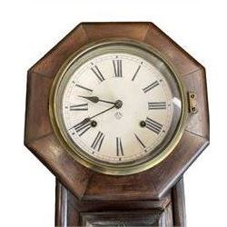 Ansonia- American 8-day oak cased drop dial wall clock with a octagonal dial frame and visible pendulum, striking the hours on a gong.