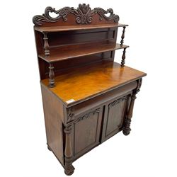 Victorian mahogany chiffonier, raised shaped pediment carved with scrolled extending foliage, two graduating shelves on turned supports, rectangular top over drawer and double cupboard, turned column pilasters, on turned feet 