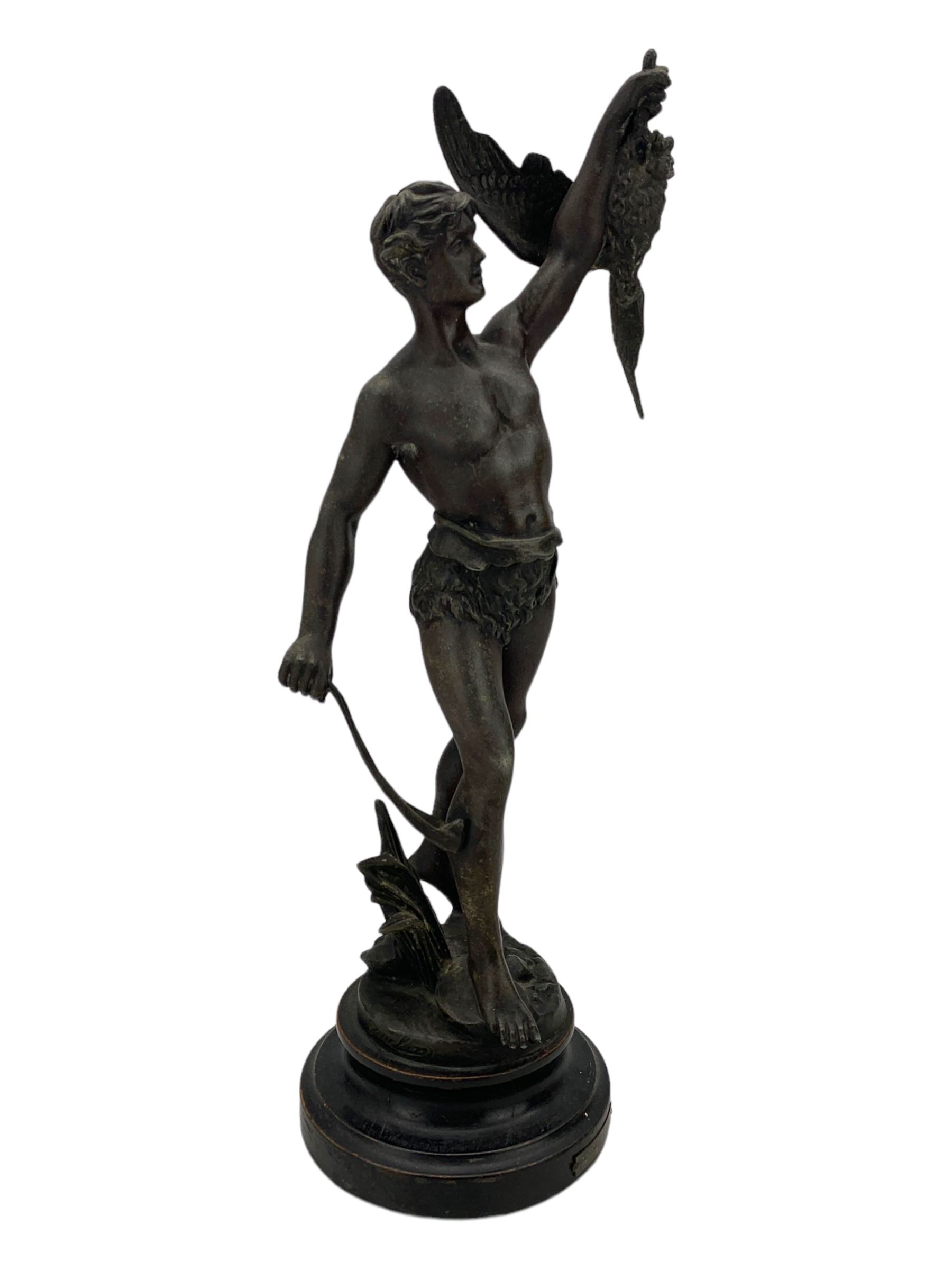 19th century French spelter figure 'Chasseur D'Aigles' on wooden base H48cm and a beaten copper circular tray inscribed with initials D61cm