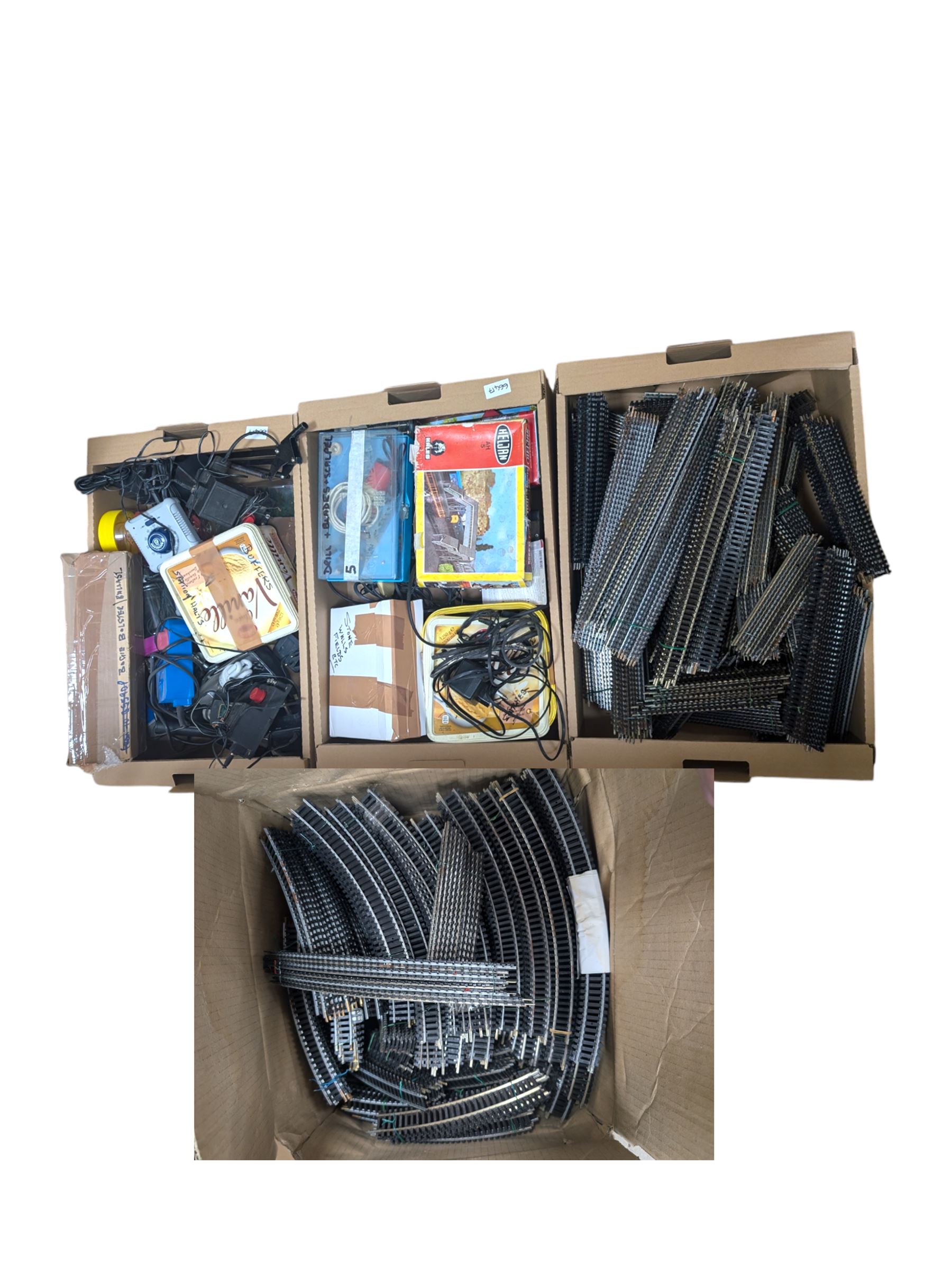 Collection of model railway accessories, including OO gauge track, control units etc, in four boxes 