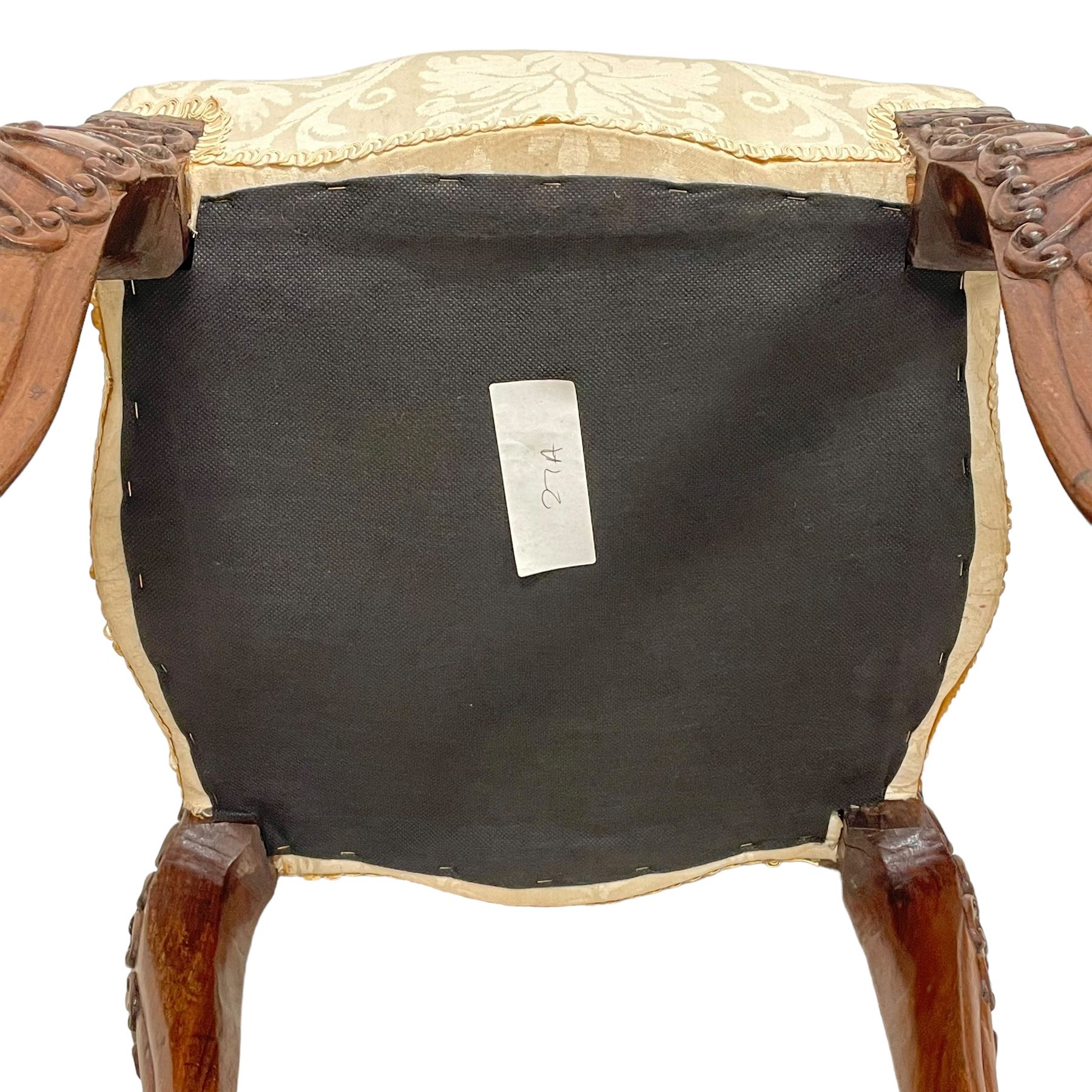 Georgian Irish mahogany dressing stool, overstuffed seat upholstered in in ivory damask fabric, the cabriole supports decorated with moulded interlacing scroll motifs with mycelium cap detail, over lobe carvings terminating to large paw feet