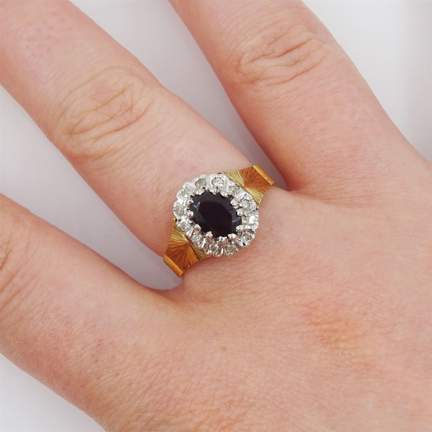 18ct gold oval cut garnet and diamond cluster ring, London 1975