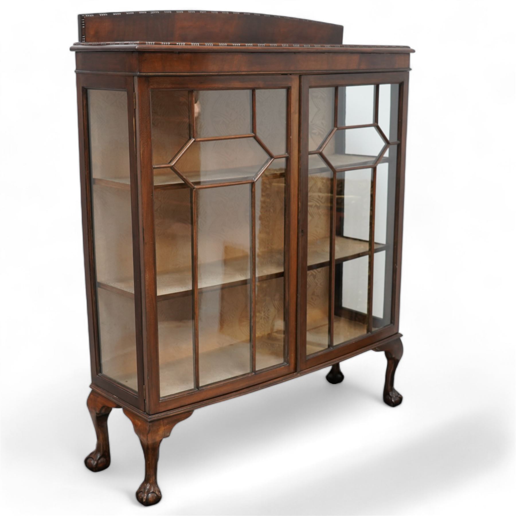 Early 20th century mahogany bow-front display cabinet, fitted with two astragal glazed doors enclosing two shelves, on cabriole supports with ball and claw feet