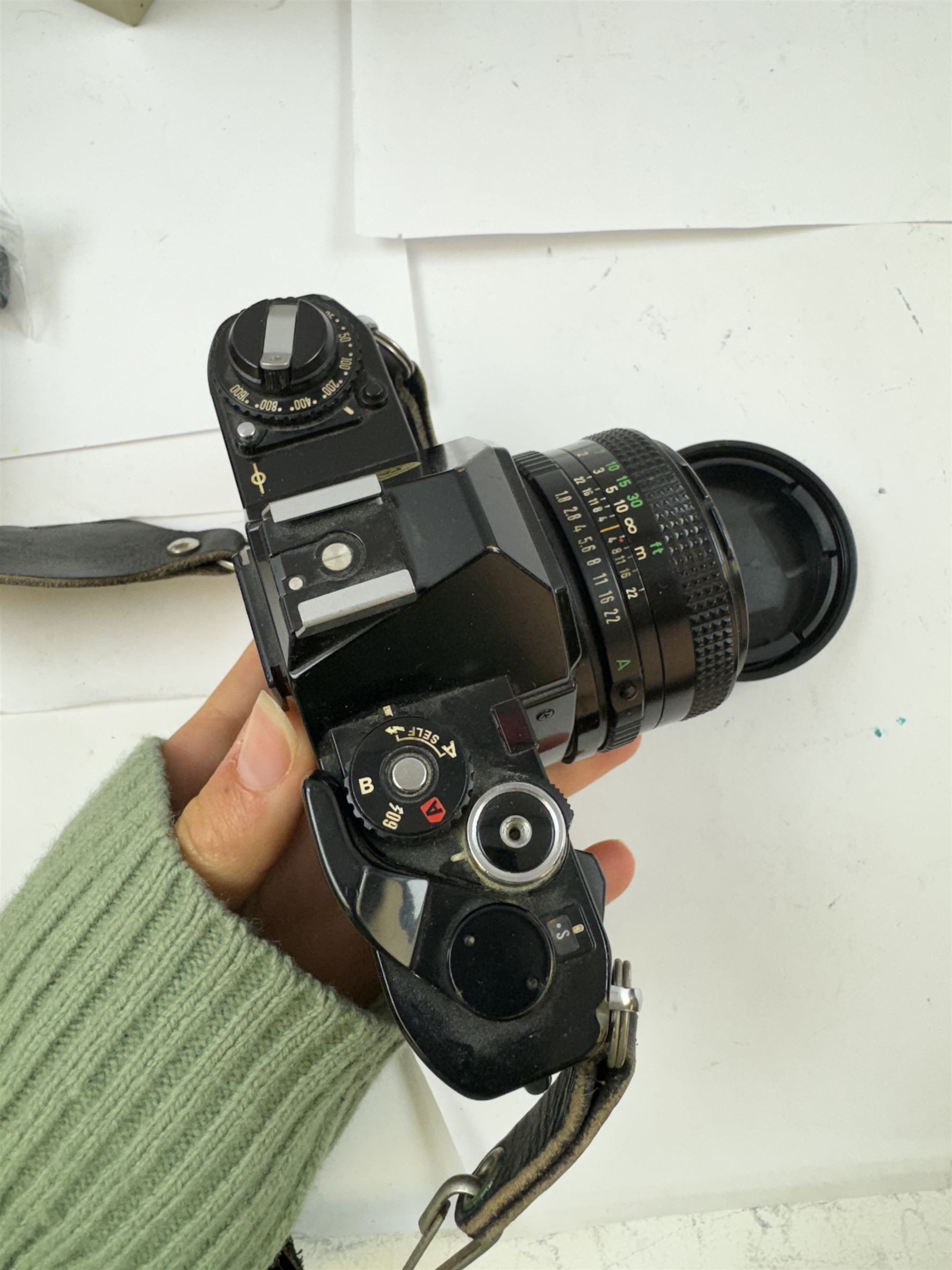 Four Canon SLR camera bodies, to include AE-1 Program, in black and silver finish, serial no. 4330401, boxed, AE-1 serial no. 1234206 and two AV-1 examples, serial nos. 841957 & 334882, one with a Canon FD 50mm 1:18 lens