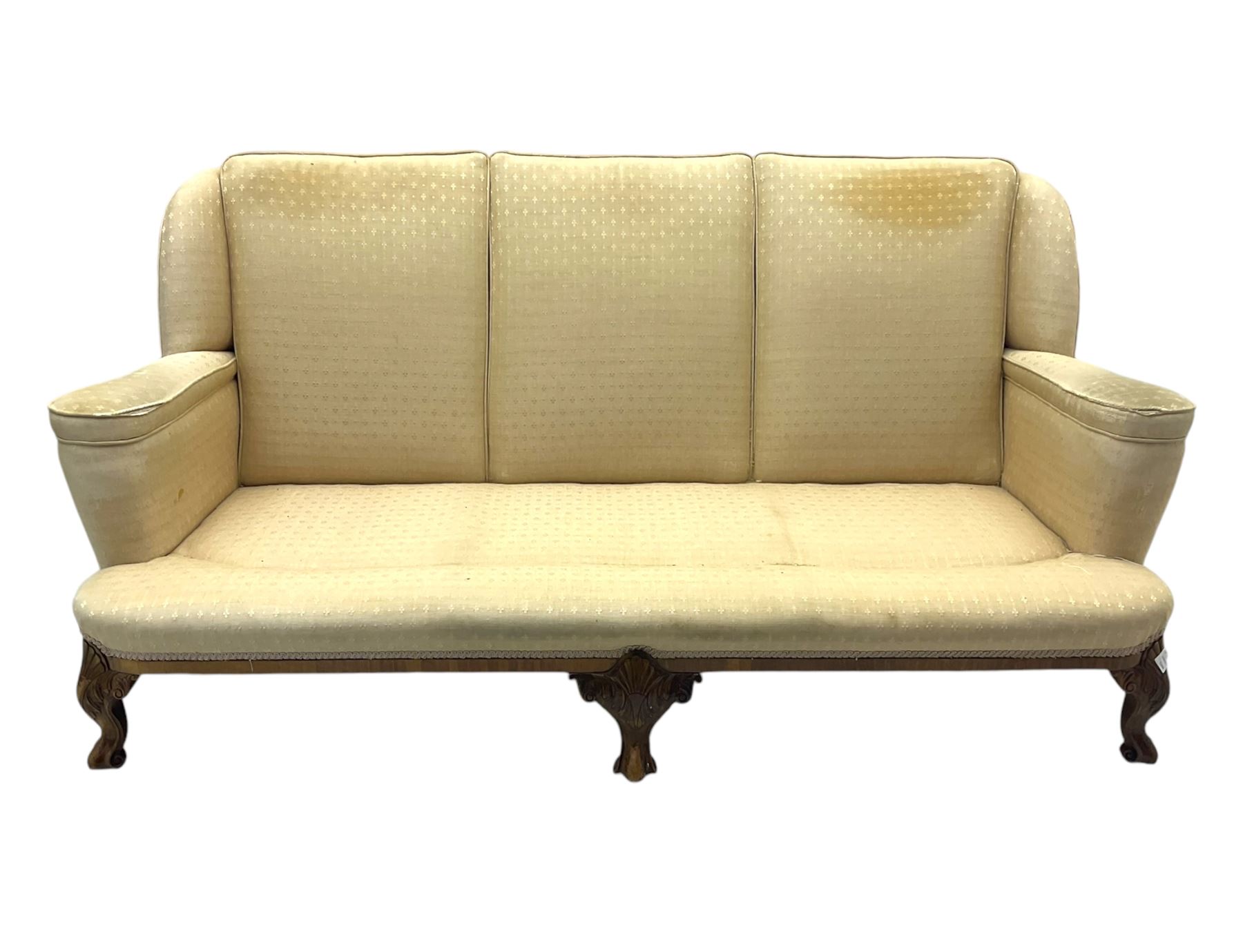 Late 20th century mahogany framed three seat sofa, upholstered in cream fabric with repeating cross pattern, raised on cabriole supports (W192cm, D98cm, H89cm); matching armchair in light pink fabric (W92cm, D98cm, H89cm) 