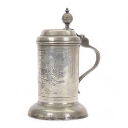 18th century Continental pewter lidded tankard, probably German, of cylindrical form, the hinged stepped cover with acorn thumbpiece above a curved handle, the body with wriggle-work decoration, upon an ovolo base, with touch marks to underside of cover, including thumb piece H22.5cm