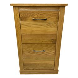 Contemporary light oak filing cabinet, rectangular top over two drawers each fitted with metal rods, on plinth base