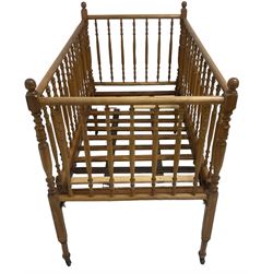 Victorian beech and pitch pine crib, turned spindle gallery supports, raised on square tapering supports with castors