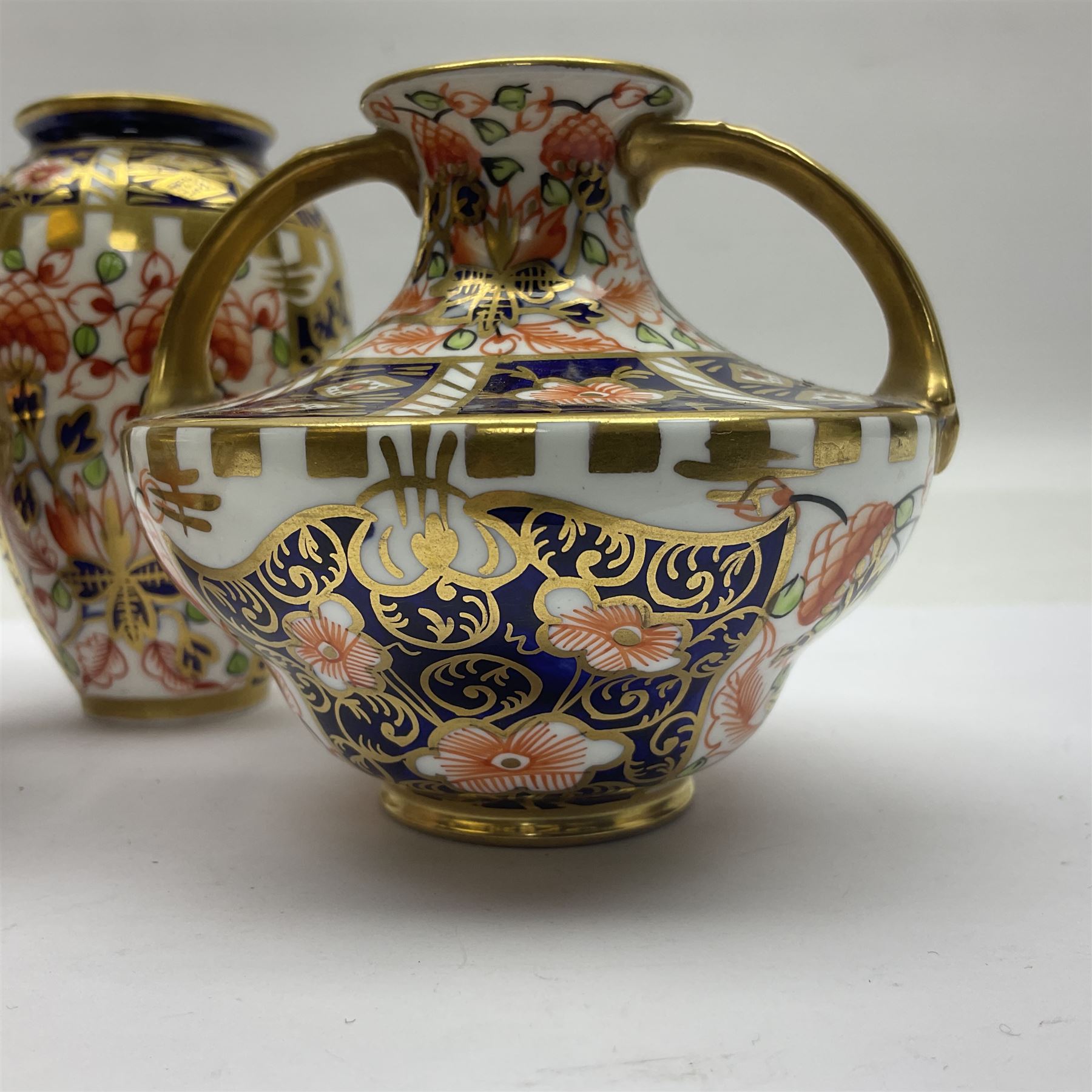 Pair of Royal Crown Derby 6299 imari miniature two-handled vases, together with another miniature vase of baluster form, all with printed mark beneath, tallest H8cm 