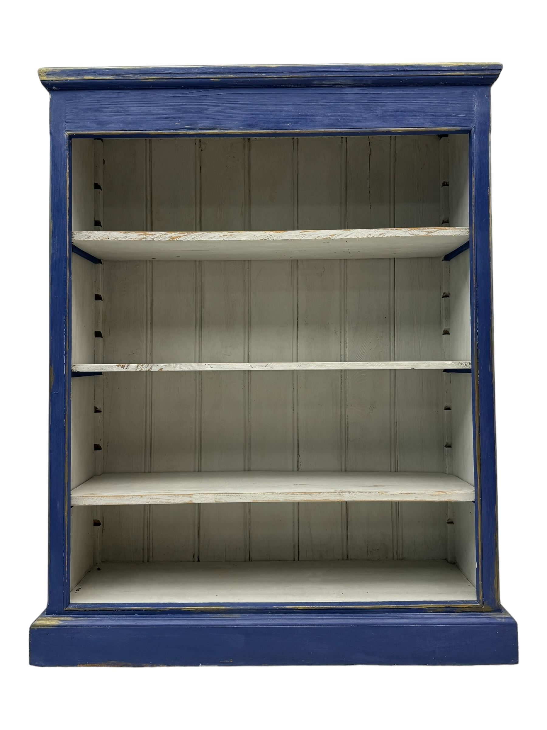 Pine blue painted open bookcase, moulded rectangular top over three white painted adjustable shelves, on plinth base