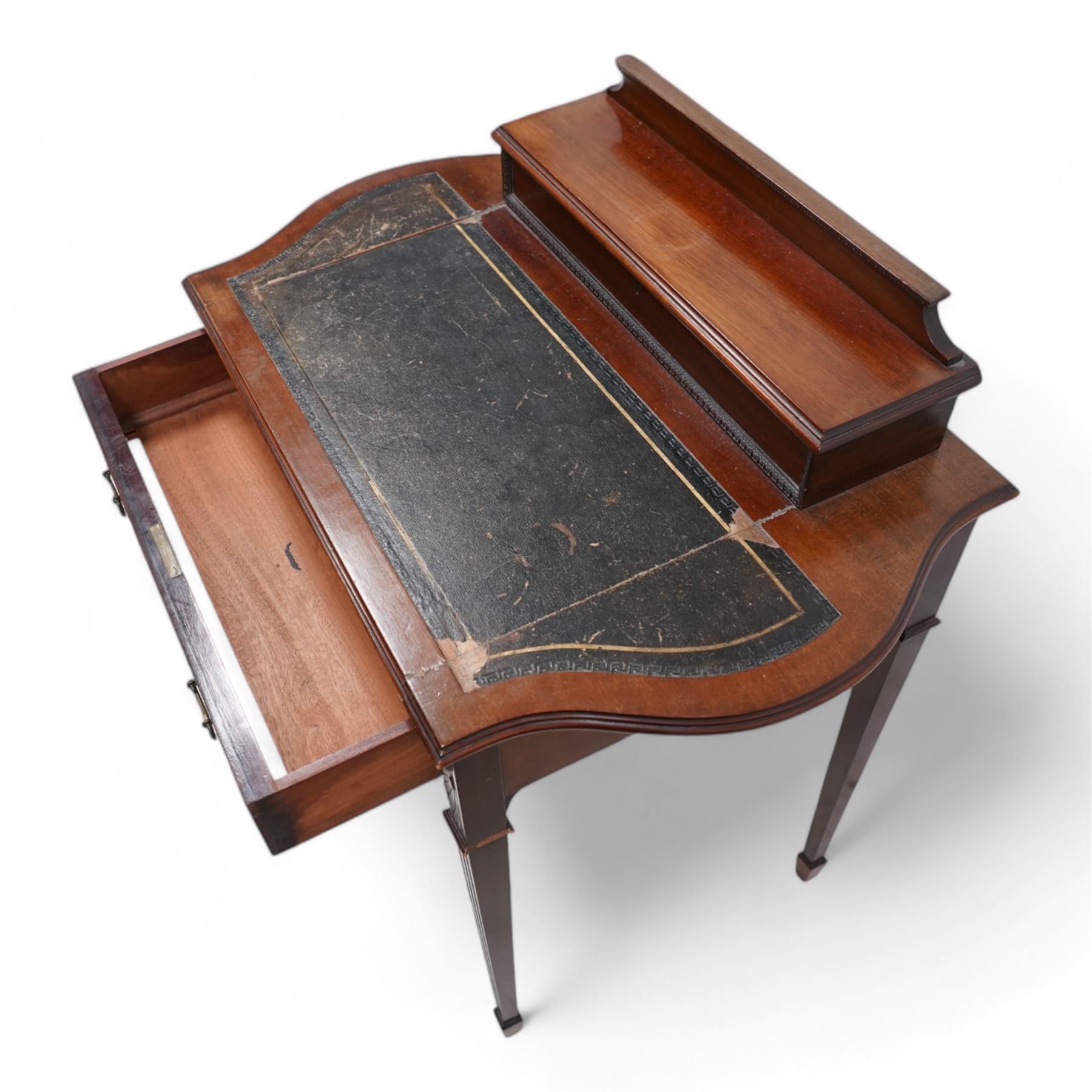 Edwardian mahogany writing desk, raised hinged compartment fitted with divisions, shaped and moulded top with leather inset, fitted with single drawer, on fluted square tapering supports with spade feet