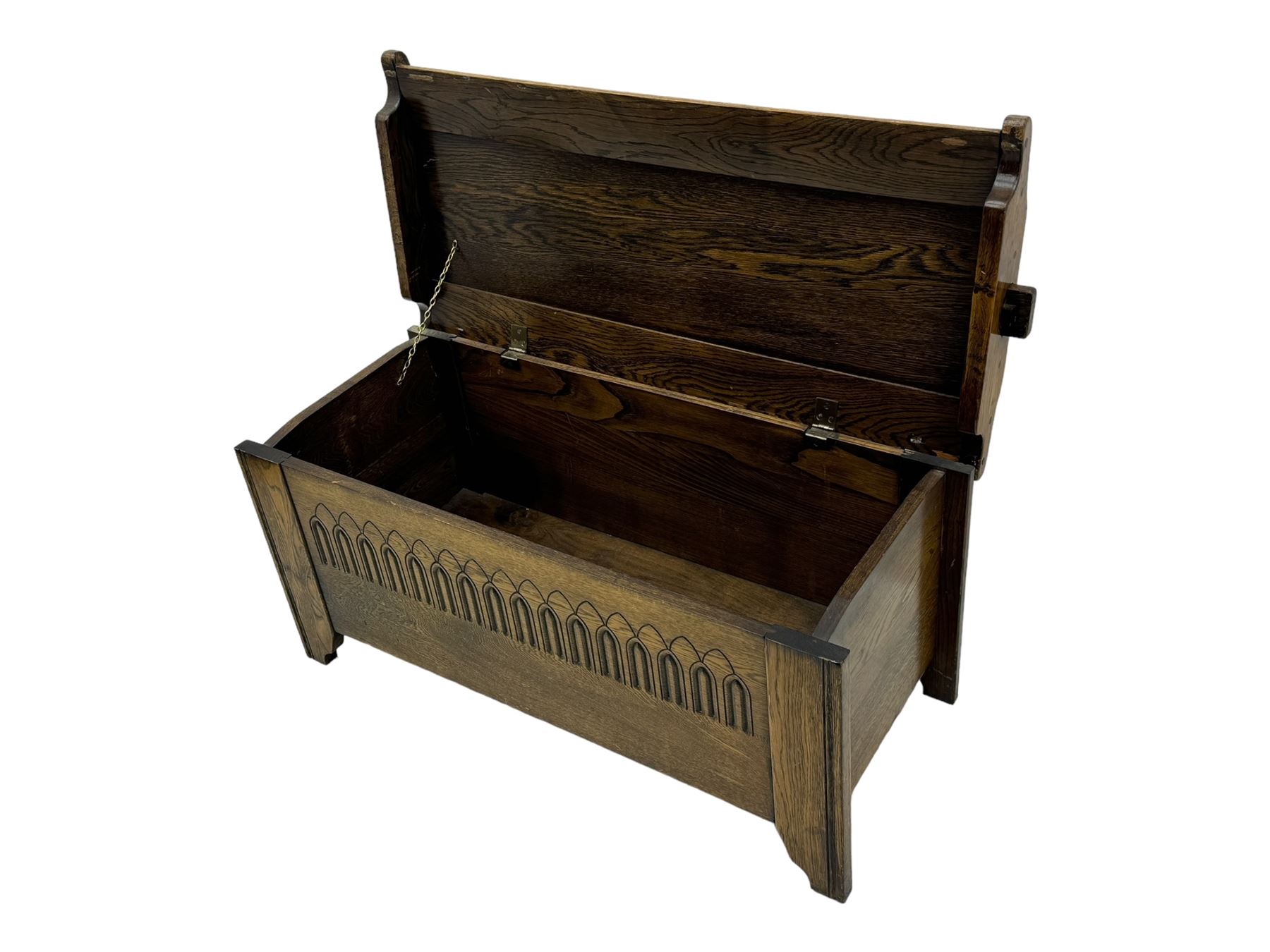 20th century oak coffer or blanket chest, rectangular hinged top over repeating Gothic arch carved front and shaped sides, constructed with pegged joints, on stile supports