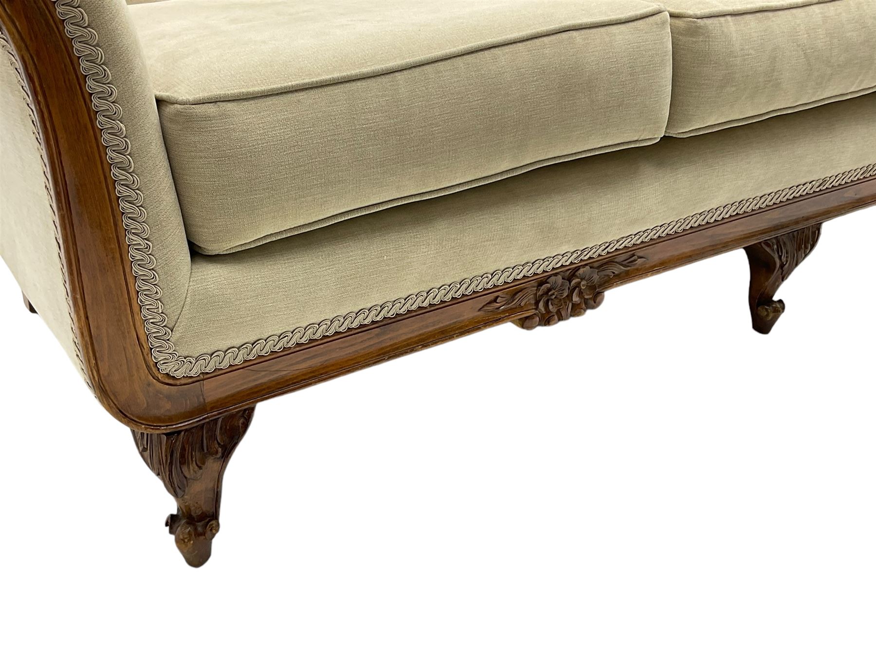 French design stained beech framed three-seat sofa, moulded frame carved with flowers and foliage, upholstered in pale neutral fabric, the moulded lower rail carved with flowerheads, on acanthus leaf carved cabriole feet