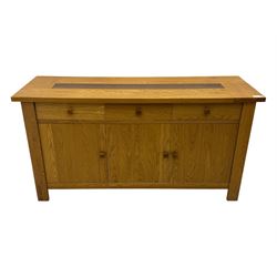 Contemporary oak sideboard, rectangular top with central contrasting plank, over three frieze drawers and three cupboards with enclosed shelving, on rectangular stile supports