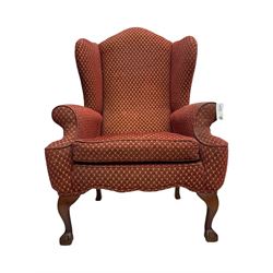 Early 20th century hardwood-framed wingback armchair, upholstered in red dotted fabric, on cabriole feet