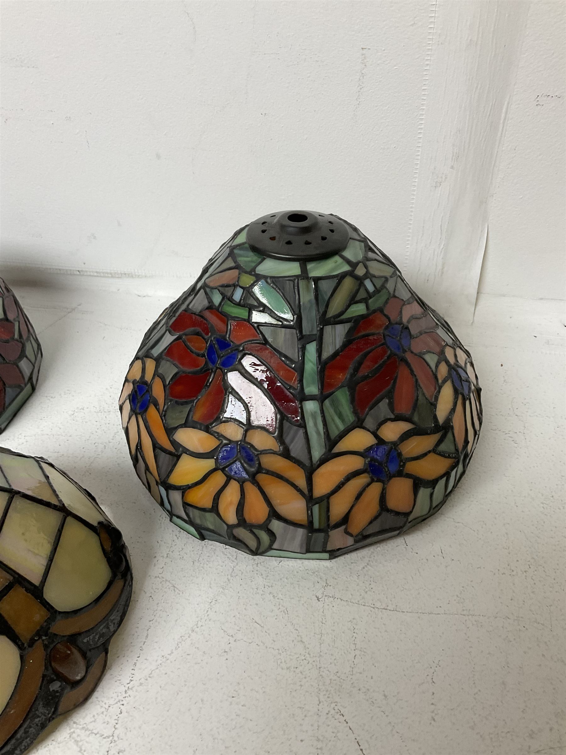 Three Tiffany style lamp shades, each with multicoloured floral decoration, largest D20.5cm