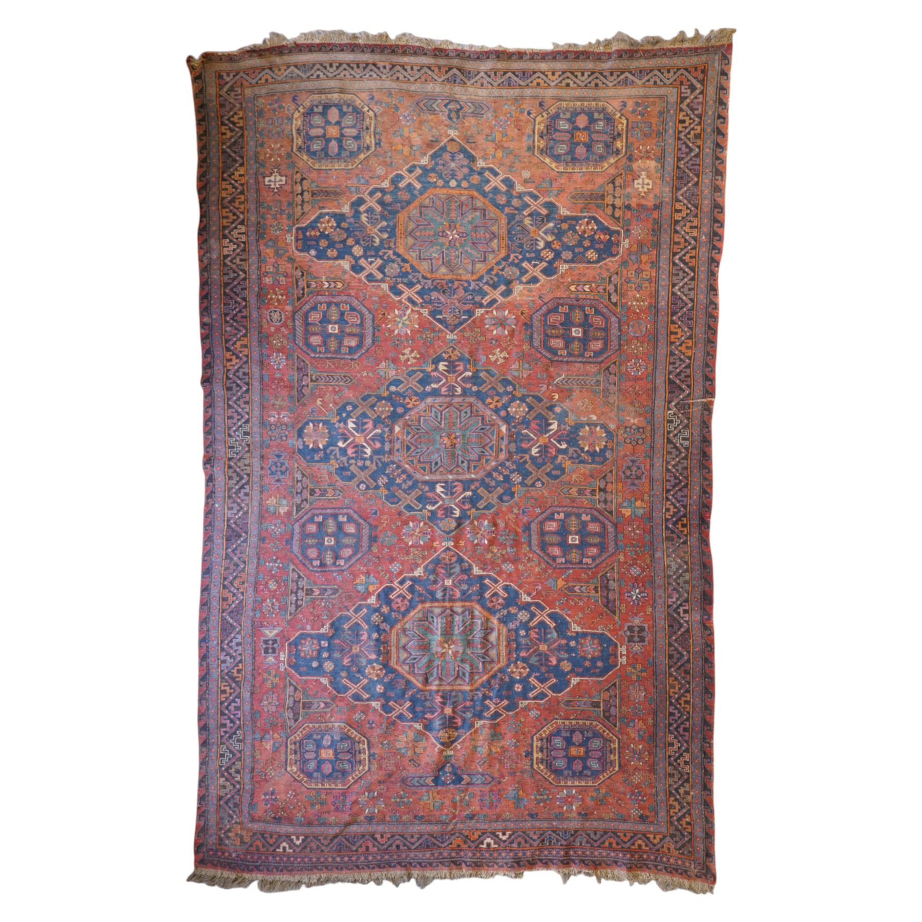 Old Persian red ground flat woven carpet, the field with three large medallions surrounded by small stylised flower head motifs, geometric border enclosed within running water band 346