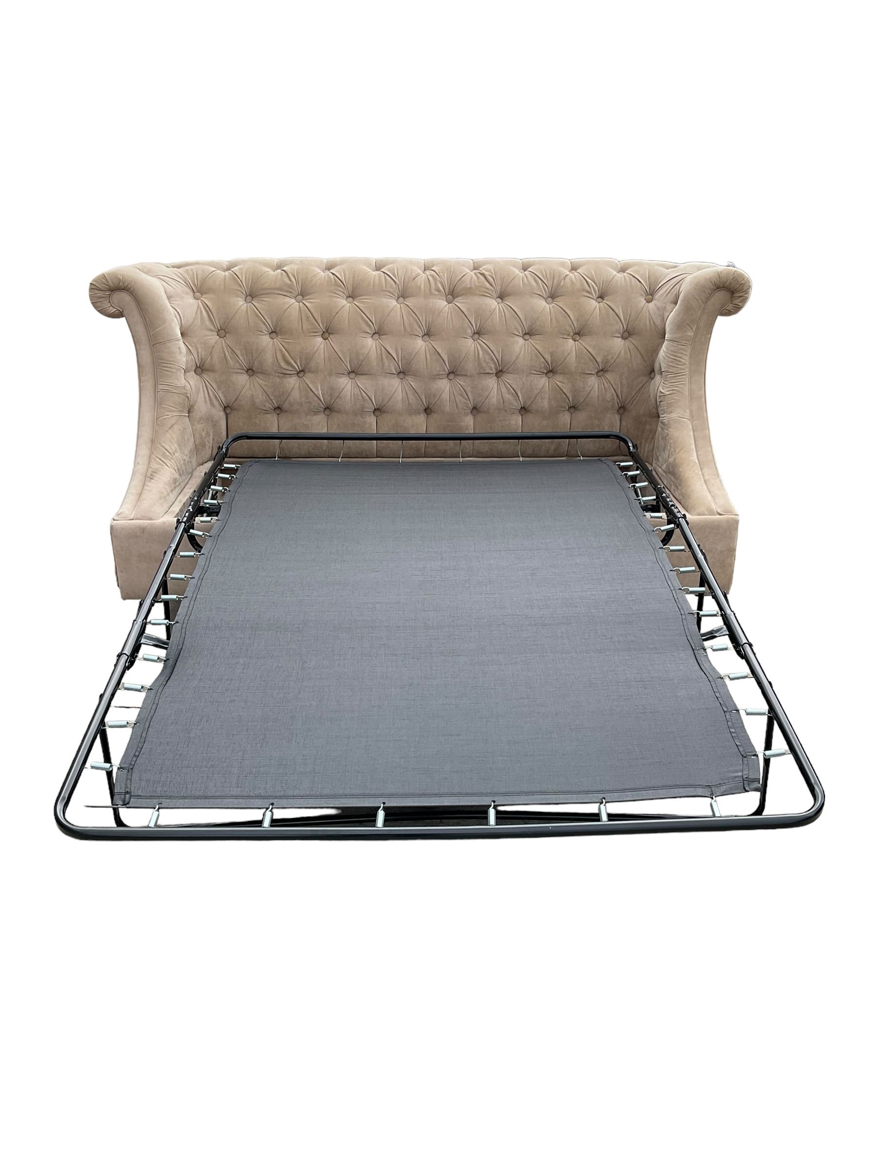 Grande wing back sofa bed, upholstered in beige buttoned fabric, metal action pull out double bed