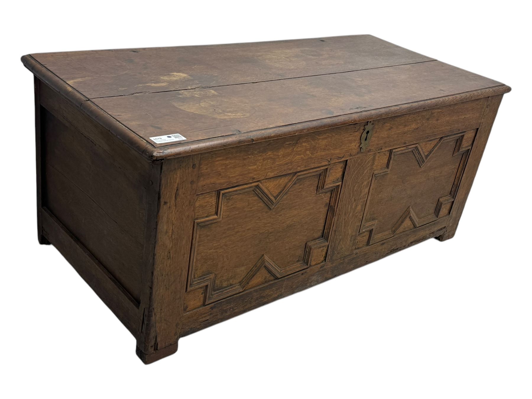 18th century oak blanket box, rectangular form with a hinged lid, the front decorated with raised geometric panelled mouldings, fitted with a central lock plate, raised on bracket feet