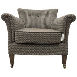 Edwardian hardwood-framed tub-shaped armchair, curved back over rolled arms, upholstered in checkered fabric with buttoned back, on square tapering supports with brass castors 