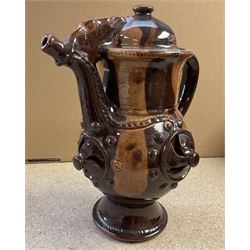 Treacle glaze pottery puzzle jug, H28cm