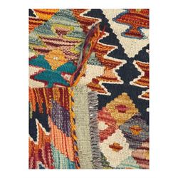 Chobi Kilim multicoloured ground runner, displaying diamond-shaped motifs in shades of blue, red, yellow, and green, accented by a bold black outline and bordered with a striped design, flatwoven with fringed edges