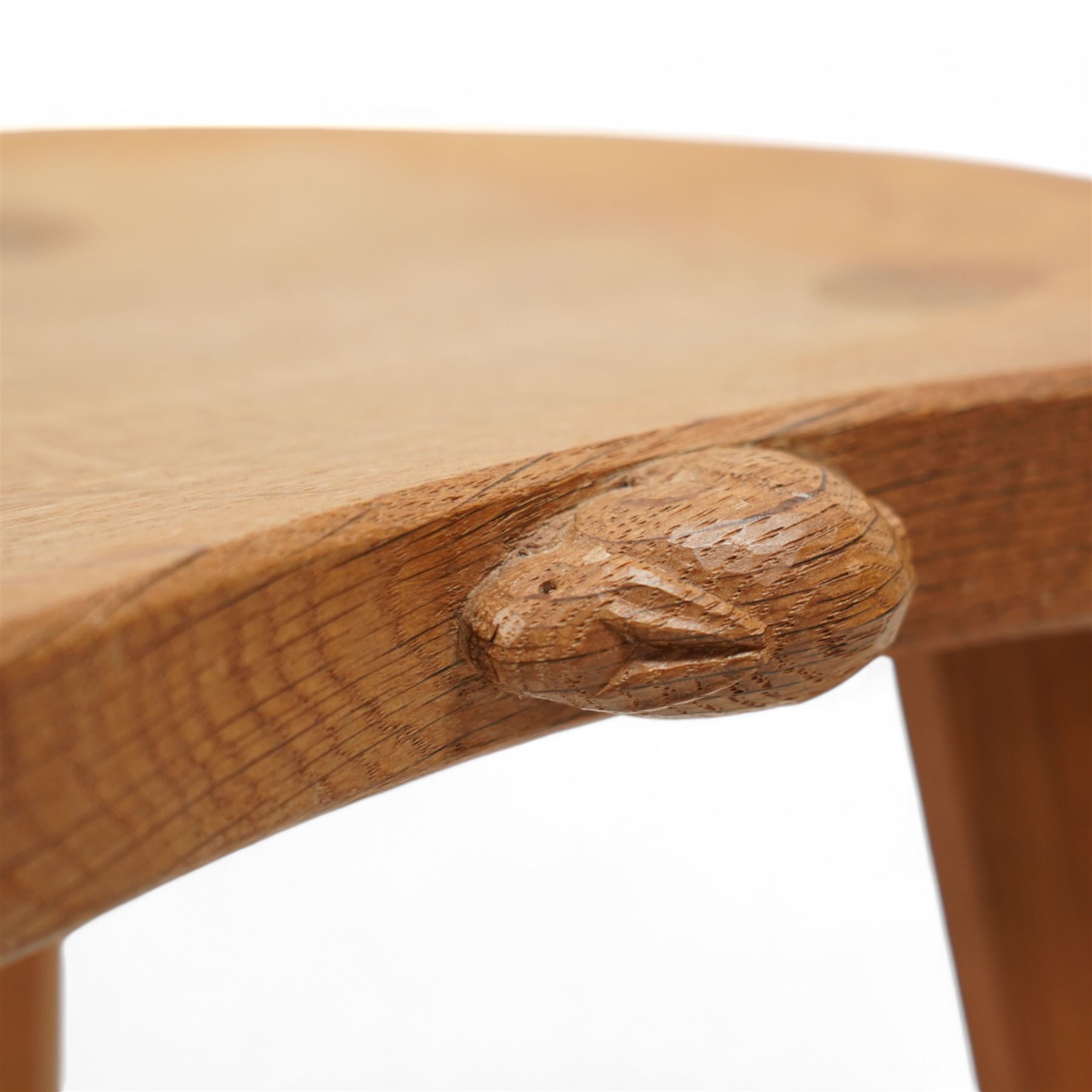 Rabbitman -  oak milking stool, dished kidney shaped top, three tapered octagonal supports, carved with rabbit signature, by Peter Heap, Wetwang