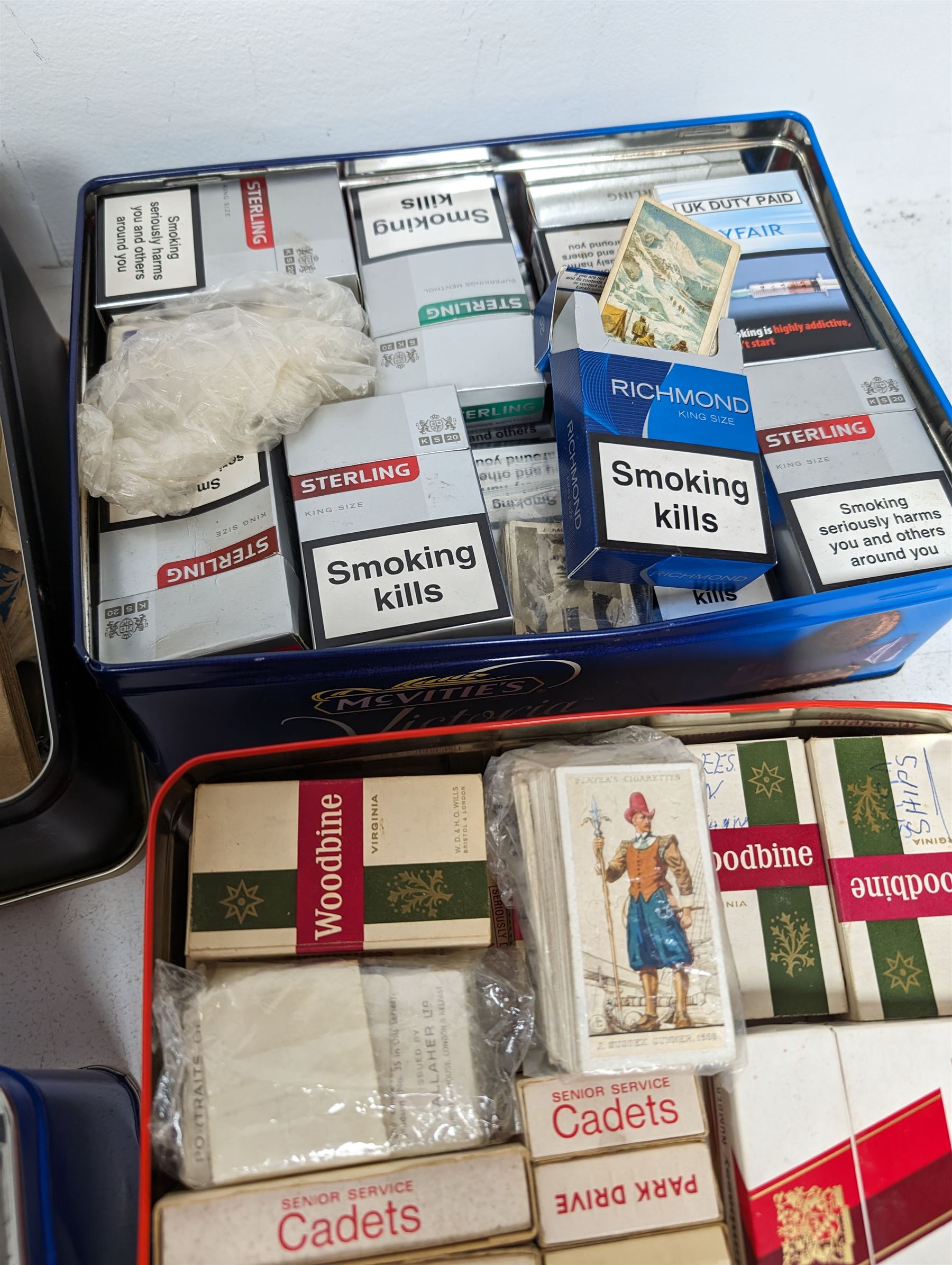 Large quantity of cigarette/tea cards, some loose and in albums, including Carreras, Bond, etc, contained within six tins, together with a Cricket How to Play book