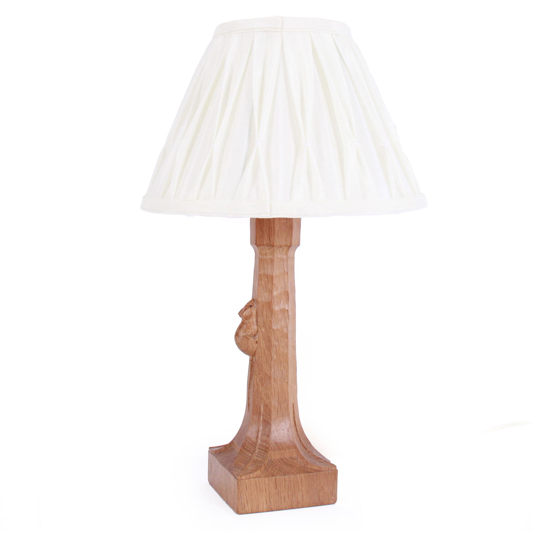 'Mouseman' tooled oak table lamp, tapered octagonal stem terminating to leaf carved square base, carved mouse signature, with pleated cream shade, by Robert Thompson of Kilburn