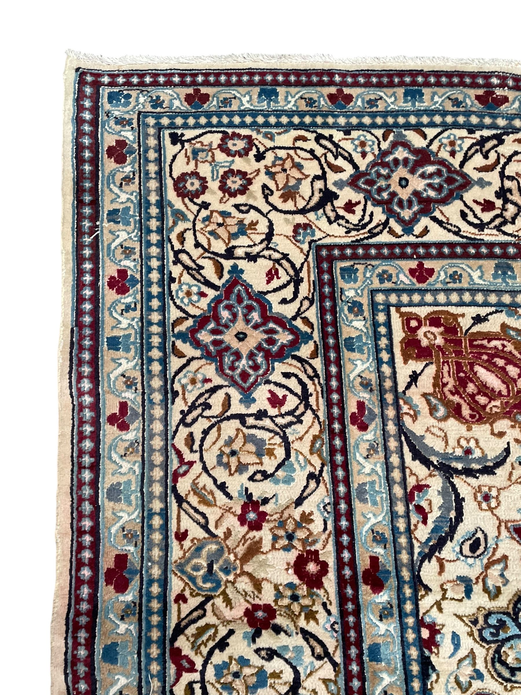 Persian Kashan olive ground carpet, central rosette medallion surrounded by swirling leafy branches and palmettes, the spandrels decorated with further palmettes and foliate motifs, scrolling border interspersed with stylised plant motifs, with in guard stripes