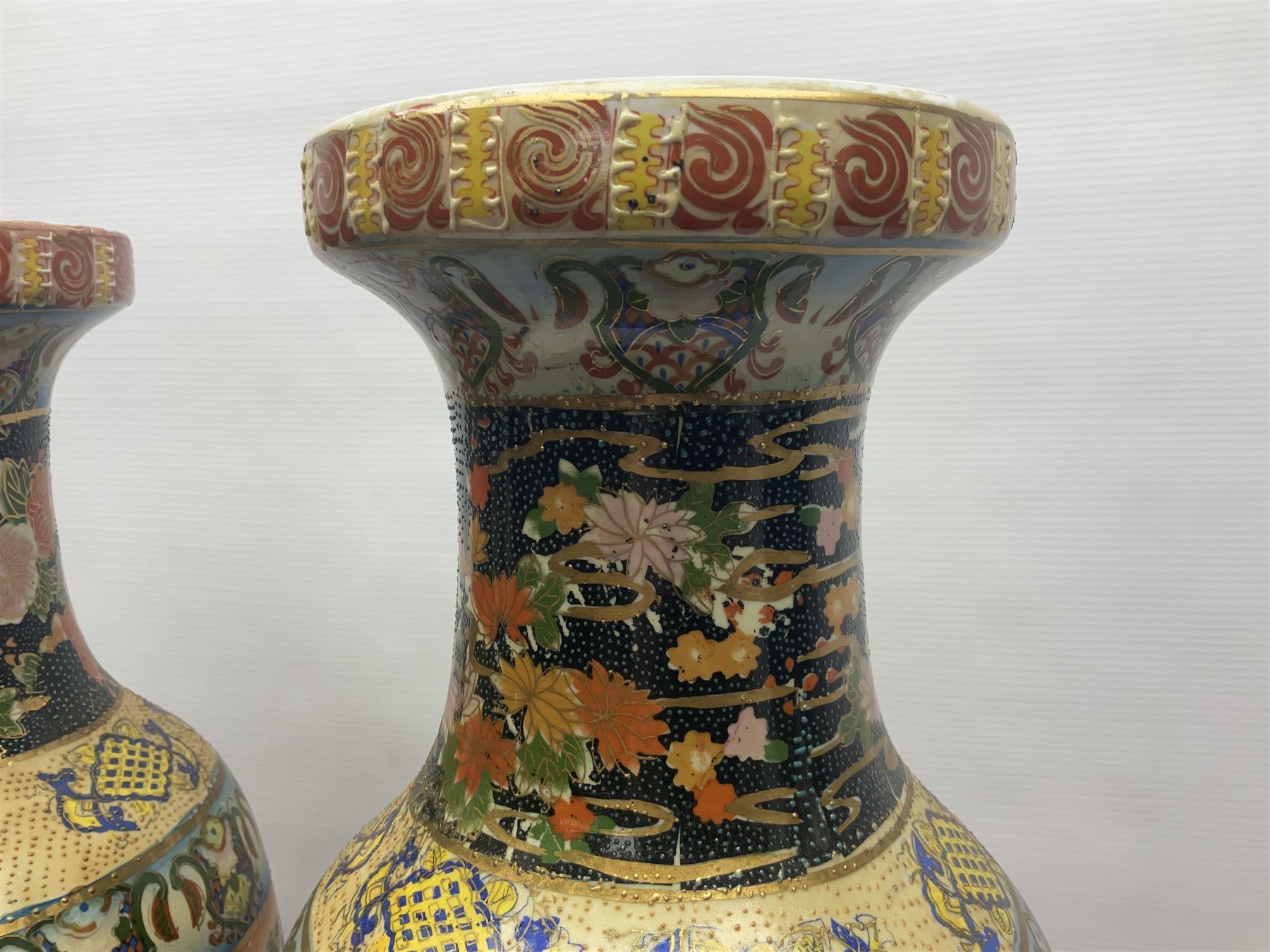 Pair of modern Satsuma vases of baluster form, decorated with figures in within river landscapes and floral borders, highlighted in gilt, H60cm