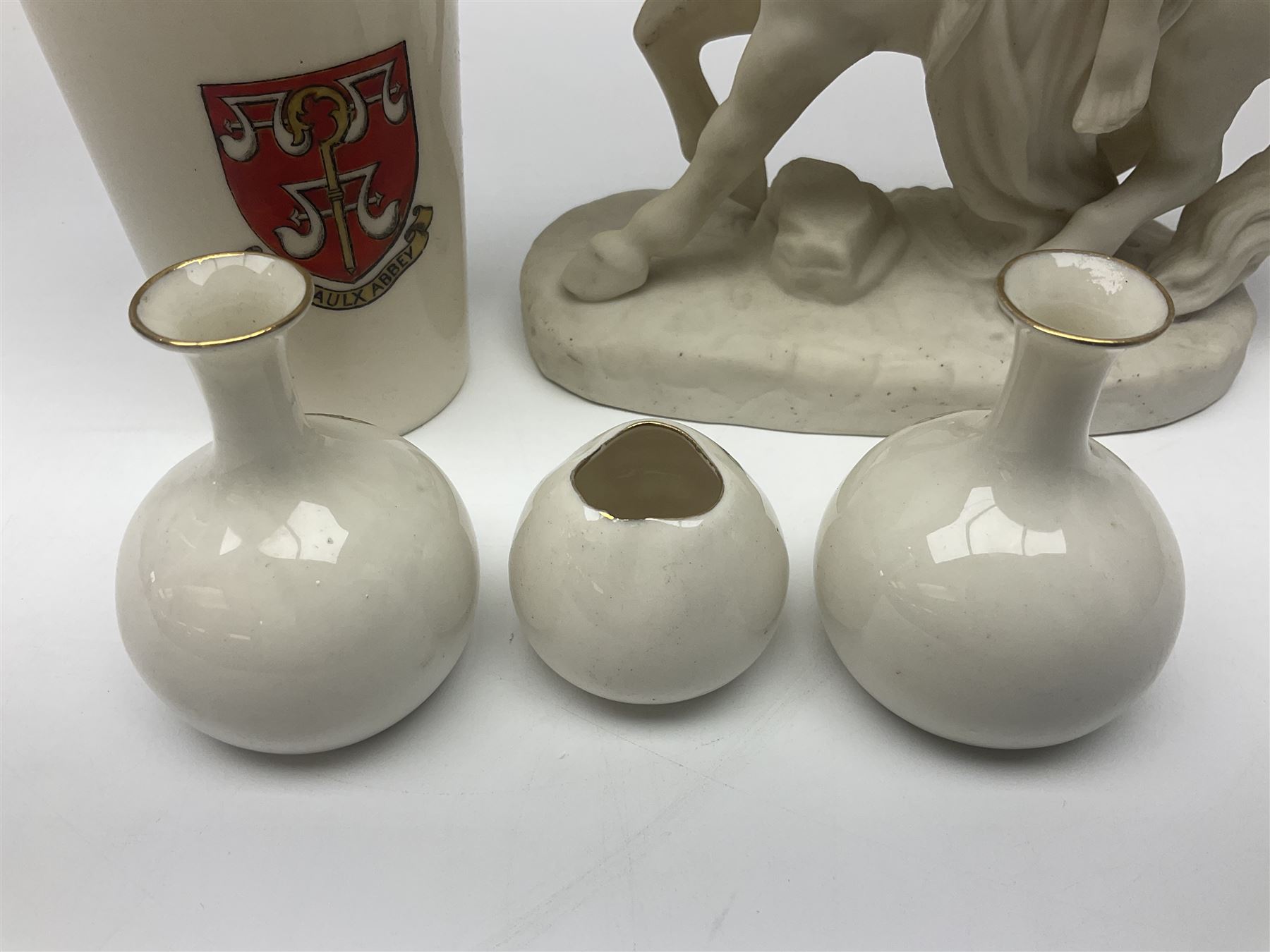 W.H.Goss Parian figure of Lady Godiva, with printed mark beneath, together with a W.H.Goss crested ware Rivaulx Abbey tumbler, and three similar Waterfall Heraldic China crested ware items, Godiva H19cm 