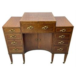 Late 19th century mahogany and satinwood dressing chest, the raised middle section hinges to reveal an interior fitted with lidded compartments, removable tray, single drawer and glass scent bottles, lift-up bevelled mirror with adjustable hinged mechanism, fitted with a further eight cock-beaded graduating drawers and curved kneehole with double cupboard, square tapering supports on brass cups and castors, inlaid throughout with checkered stringing, ornate Rococo cast gilt metal handles