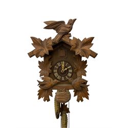 German 1960's cuckoo clock with automata - traditional styled case and dial with a cuckoo sounding the hours and half-hours, twin chain driven movement and automata feature of two carved cuckoos to the front of the case simultaneously moving as the hours are struck. With weights and pendulum.  