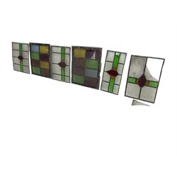 Six leaded stained glass window panes, largest measuring - 46cm x 41cm