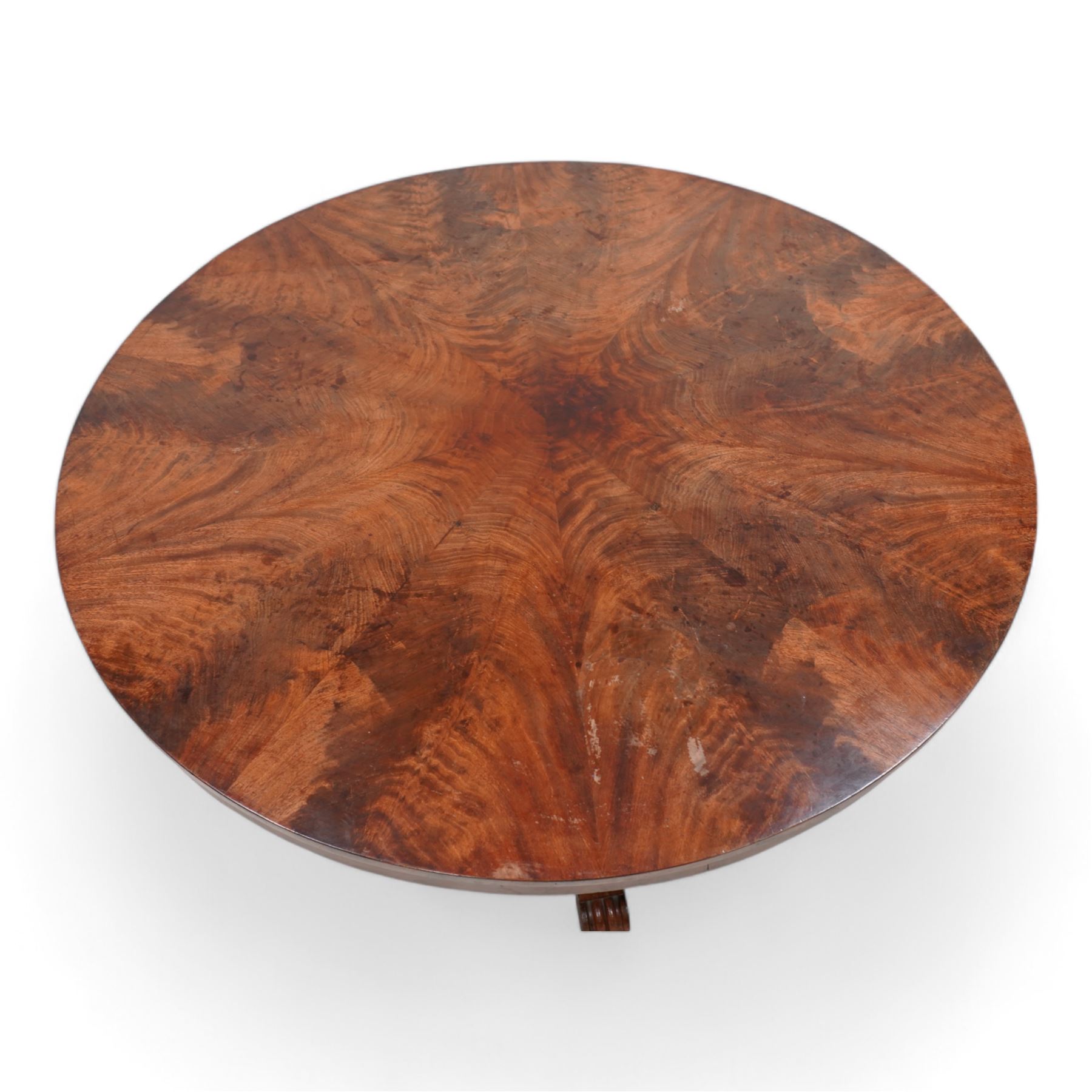 Victorian mahogany breakfast centre table, circular tilt-top with figured segmented veneers, tapering octagonal column on concaved triangular platform, scrolled carved feet 