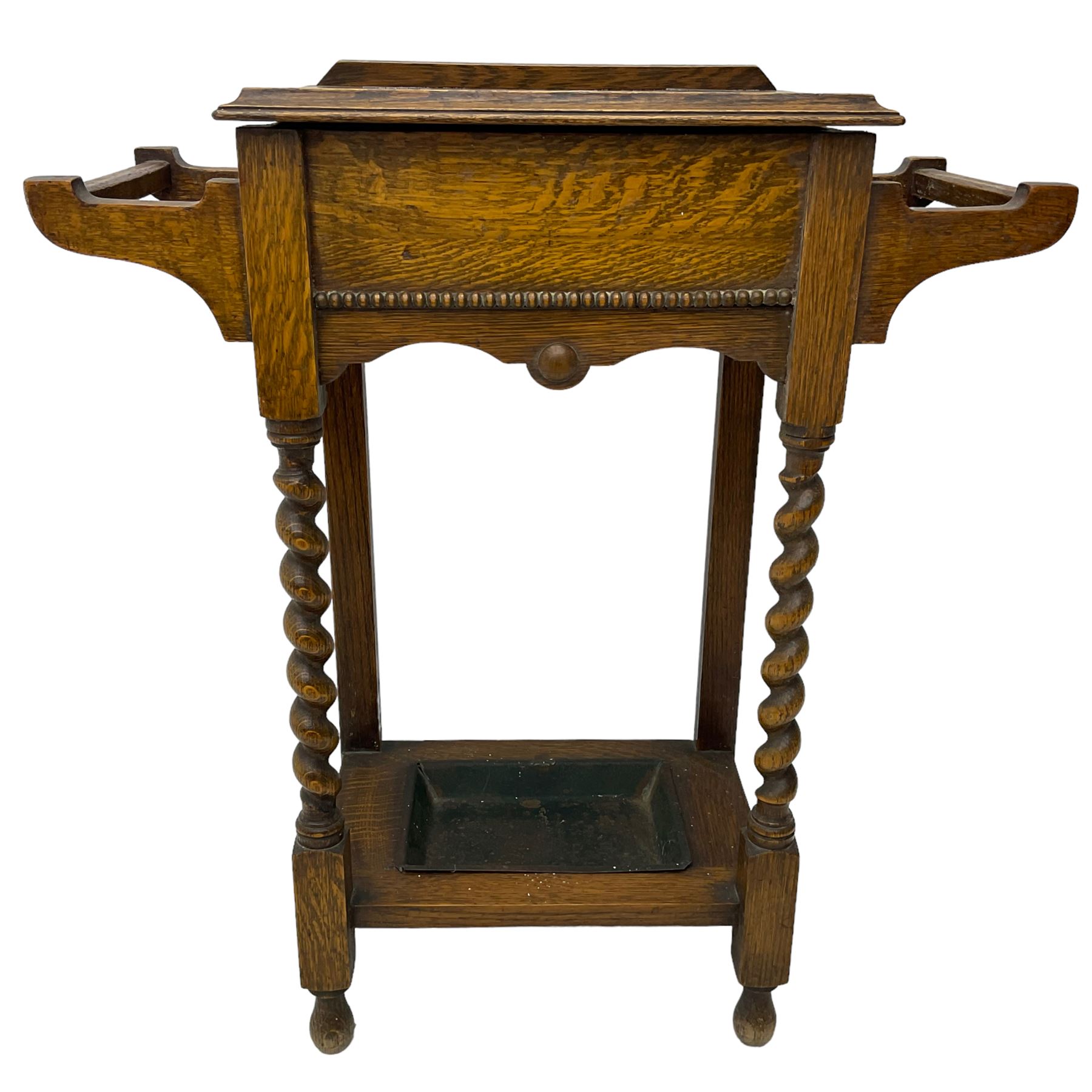 Early 20th century oak work table or hall stand, rectangular top with hinged lid enclosing interior storage, side hanging handles, barley twist supports united by square stretchers, on turned feet