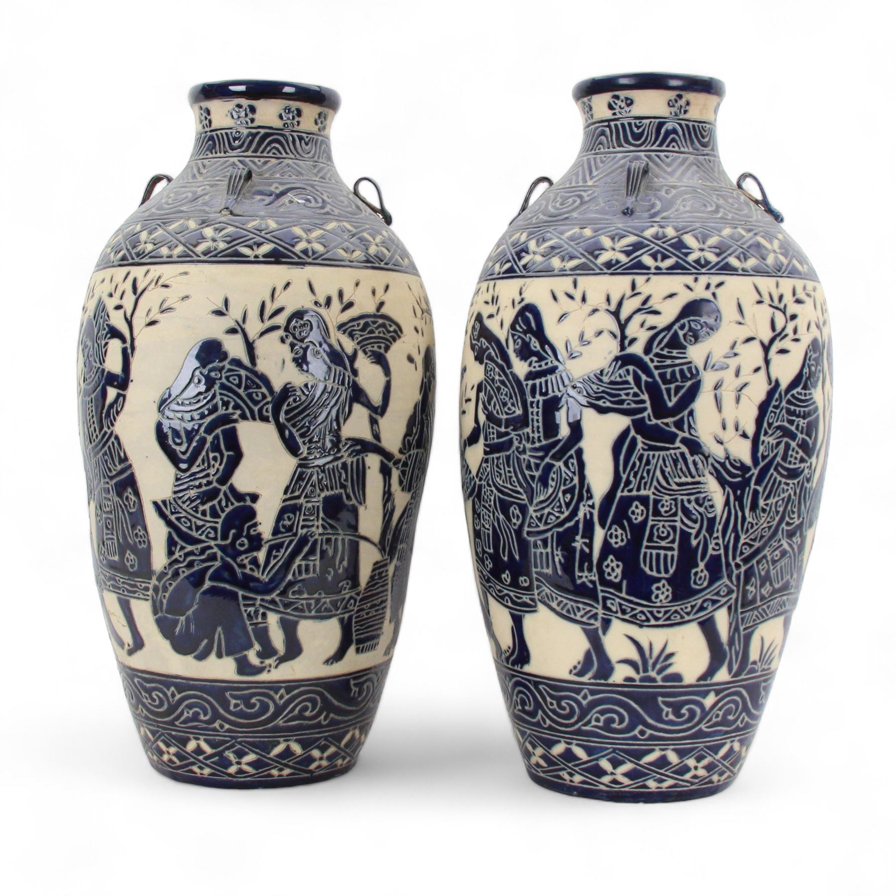 Pair of blue and white Cretan style vases, decorated with figures among trees with blue boarders on a white ground, H55cm