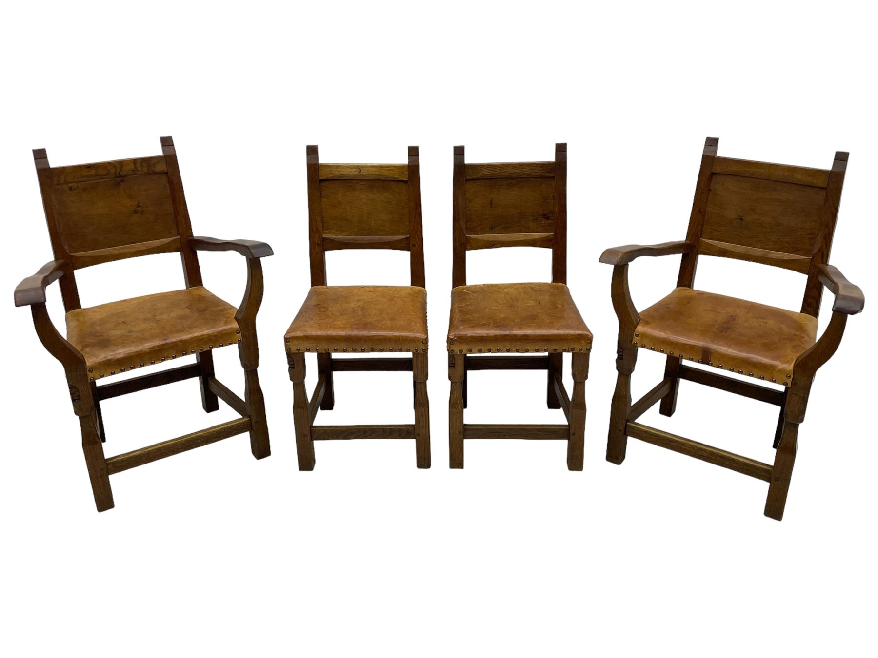 Gnomeman - set of eight (6+2) oak dining chairs, adzed panelled back over tan leather upholstered seat with applied stud band, on square supports united by plain stretchers, each chair carved with gnome signature, by Thomas Whittaker, Littlebeck, Whitby