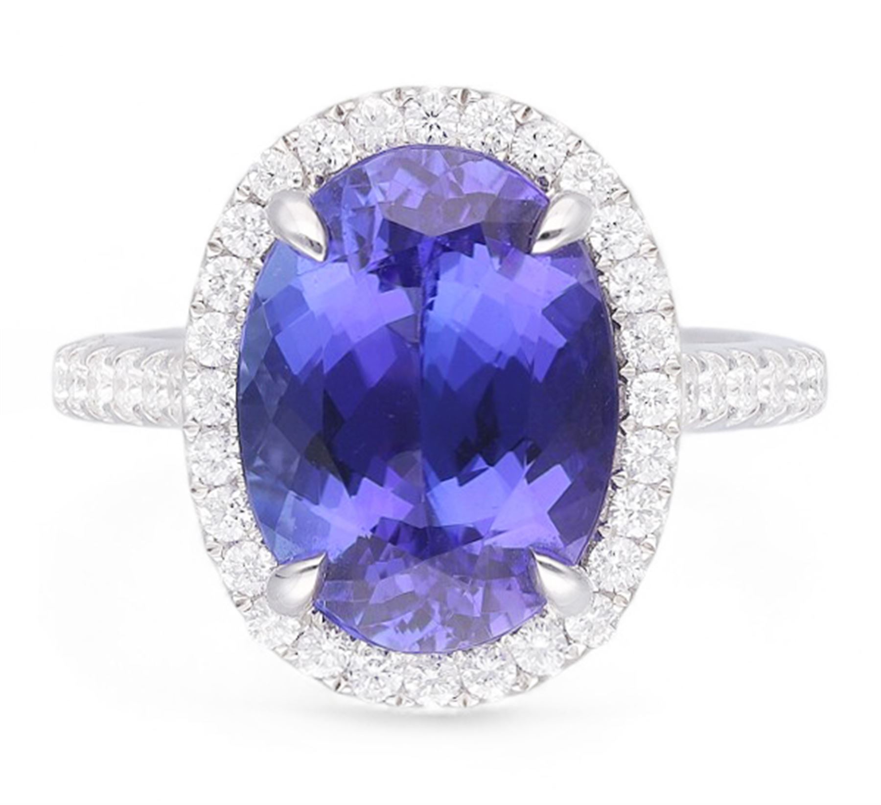 18ct white gold oval cut tanzanite and round brilliant cut diamond cluster ring, with diamond set shoulders, hallmarked, tanzanite 5.83 carat, total diamond weight 0.54 carat