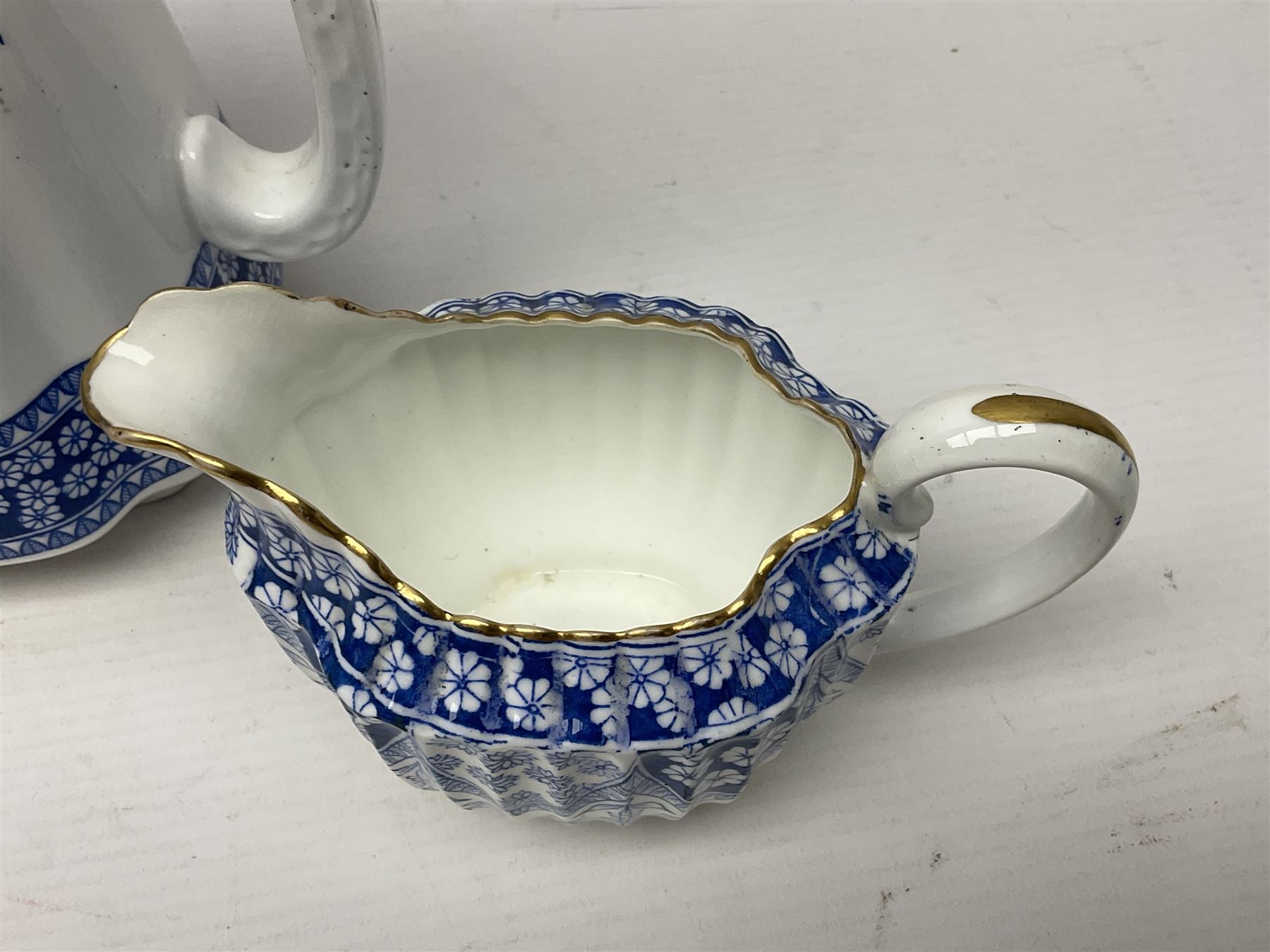 Late Victorian W T Copeland & Sons Primrose pattern coffee set for six, pattern no 2724, comprising coffee pot, milk jug, sugar bowl and six coffee cans and saucers, all upon a Lazy Susan, of circular form, with gilded rim and upon domed pedestal foot, with printed mark beneath, D44.5cm