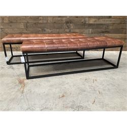 Two rectangular metal framed benches, upholstered in buttoned tan leather