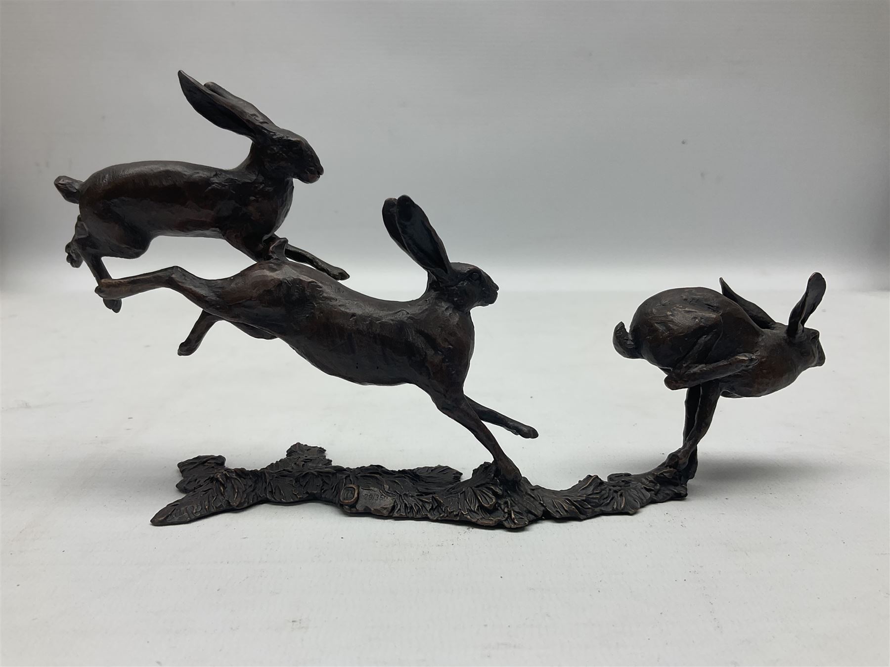 Michael Simpson: bronze Small Hares Running, modelled as three hares, limited edition 29/350, with certificate, H11cm 