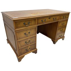 Georgian design yew wood twin pedestal desk, moulded rectangular top over nine cock-beaded drawers, on bracket feet