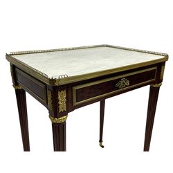 Late 19th century French figured plum pudding mahogany side table, canted rectangular white marble top with raised gilt metal gallery, fitted with a single frieze drawer, central extending floral cast ormolu escutcheon and applied moulded edging, on tapering turned and fluted supports with brass cups and castors, decorated with cast foliate mounts and foliate cast collars 