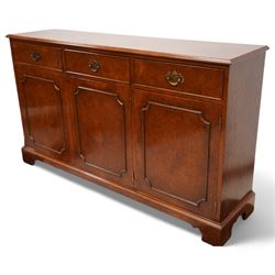 Georgian design figured walnut sideboard, moulded rectangular top over three drawers and three cupboards, on bracket feet 