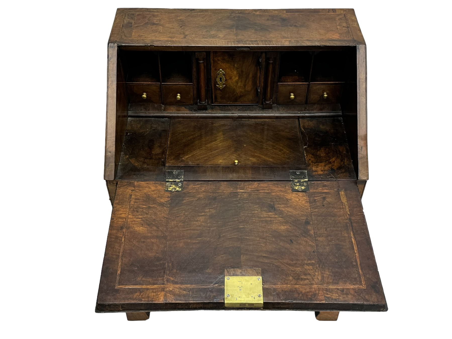 18th century walnut bureau, fall-front enclosing fitted interior with drawers and pigeonholes, over two short and two long drawers with brass escutcheon plates and handles, raised on bracket feet