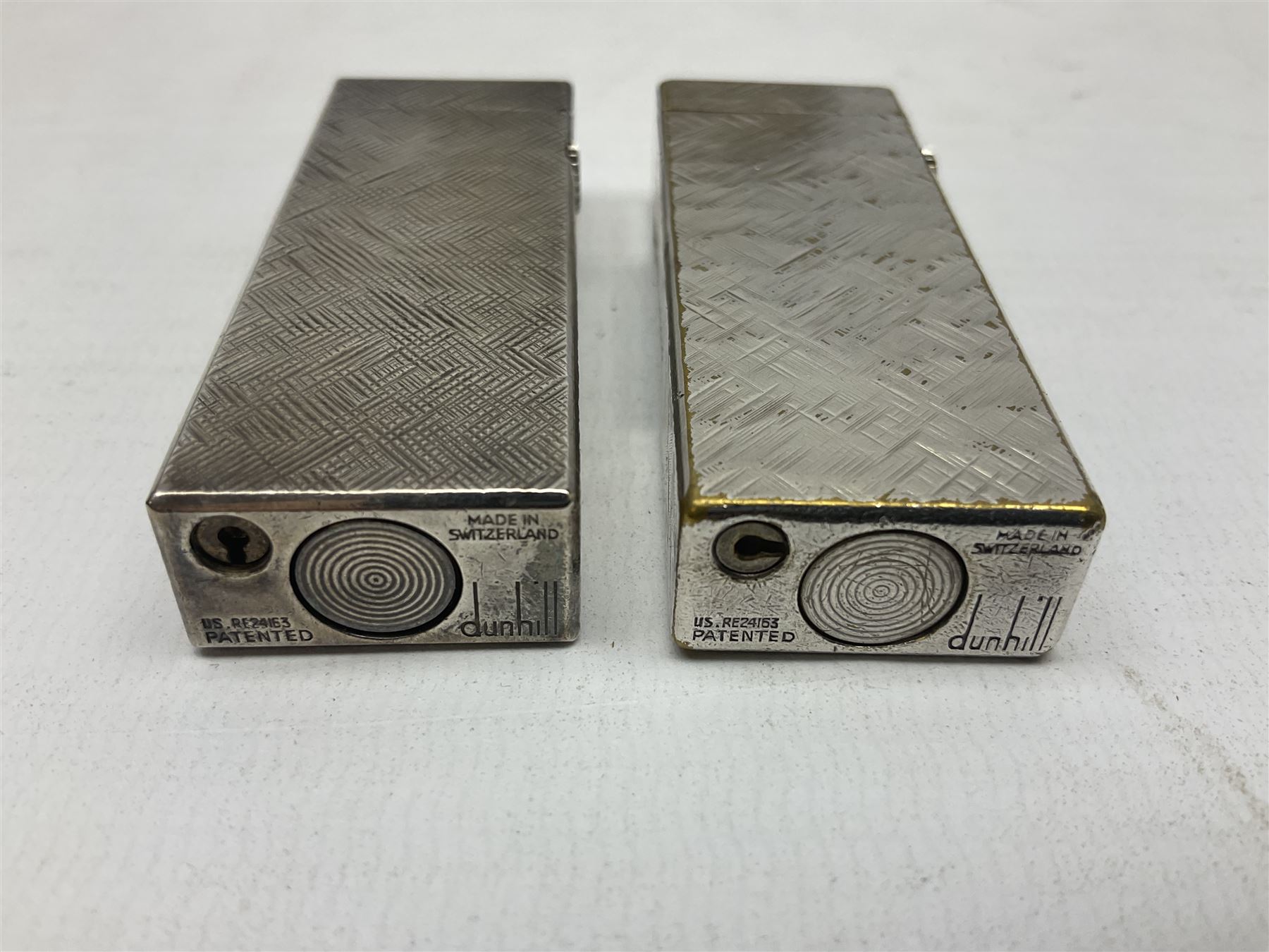 Three Dunhill silver plated lift-arm lighters, of rectangular form with engine turned decoration, marked Dunhill, two with original cases 