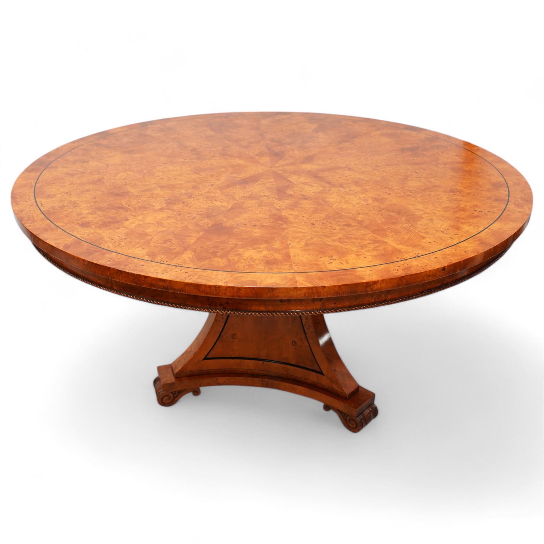 Regency design figured elm centre table, circular top with segmented veneers and ebony band, the frieze decorated with applied twist moulding, on tapered triangular pyramid pedestal, S-scroll carved feet