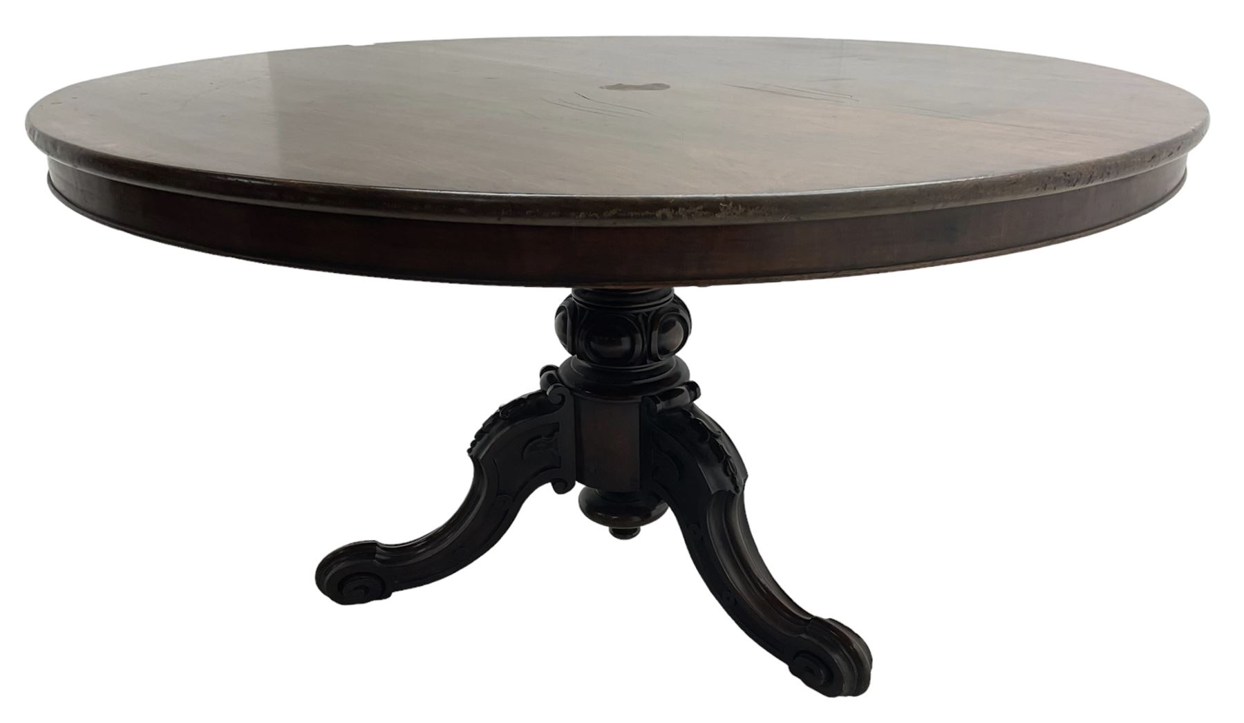 Victorian mahogany breakfast table, the circular tilt-top on carved pedestal, three moulded supports carved with bellflowers and scrolled terminals 